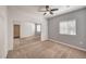 Bedroom with neutral carpet, ceiling fan, and mirrored closet doors at 5250 S Rainbow Blvd # 2046, Las Vegas, NV 89118