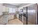 Kitchen with stainless steel appliances, white cabinets and light granite countertops at 5250 S Rainbow Blvd # 2046, Las Vegas, NV 89118