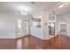 Spacious living room featuring hardwood floors, white walls and a modern light fixture at 5250 S Rainbow Blvd # 2046, Las Vegas, NV 89118