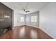 A bright living room features hardwood floors, a ceiling fan, and a modern fireplace at 5250 S Rainbow Blvd # 2046, Las Vegas, NV 89118