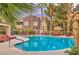 Community pool area with lounge chairs and rock waterfall feature at 5250 S Rainbow Blvd # 2046, Las Vegas, NV 89118