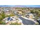 Expansive aerial view of a neighborhood with tree-lined streets and mountain views at 5640 Coe Estates Ct, Las Vegas, NV 89149