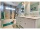 Charming bathroom with double vanity, white cabinets, and tiled shower/tub combination at 5640 Coe Estates Ct, Las Vegas, NV 89149