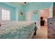 Inviting bedroom with blue accent wall, a plush bed, and neutral color scheme at 5640 Coe Estates Ct, Las Vegas, NV 89149