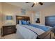 Comfortable bedroom featuring a plush bed with blue accents and dark wood furnishings at 5640 Coe Estates Ct, Las Vegas, NV 89149