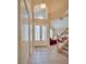 Bright and spacious foyer with tile flooring and an open view of the living area at 5640 Coe Estates Ct, Las Vegas, NV 89149