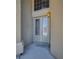 Elegant front door with glass inserts and a welcoming light fixture at 5640 Coe Estates Ct, Las Vegas, NV 89149