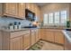 A bright kitchen with granite countertops, wooden cabinets, and stainless steel appliances, with natural light at 5640 Coe Estates Ct, Las Vegas, NV 89149