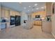 A well-lit kitchen features tile floors, ample wooden cabinetry, and modern black appliances at 5640 Coe Estates Ct, Las Vegas, NV 89149