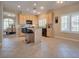 A kitchen with tile floors, bar seating, and granite countertops, with an open view to the dining room at 5640 Coe Estates Ct, Las Vegas, NV 89149