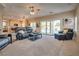 A spacious living room with sliding glass doors that lead to a beautiful outdoor pool area at 5640 Coe Estates Ct, Las Vegas, NV 89149