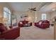 Cozy living room with comfortable seating, carpeted floors, and ample natural light at 5640 Coe Estates Ct, Las Vegas, NV 89149