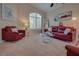 Bright living room with plush seating, contemporary decor, and large windows at 5640 Coe Estates Ct, Las Vegas, NV 89149