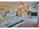 Large main bedroom with a bed, vaulted ceiling, decor, and sliding barn door to the bathroom at 5640 Coe Estates Ct, Las Vegas, NV 89149