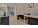 Office with a wooden desk and rolling chair; hall and stairway visible through the door at 5640 Coe Estates Ct, Las Vegas, NV 89149