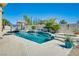 Beautiful backyard pool featuring a waterfall and lush landscaping, perfect for relaxing at 5640 Coe Estates Ct, Las Vegas, NV 89149