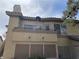 Exterior view of a multi-story home with a balcony and outdoor lighting at 5710 E Tropicana Ave # 2033, Las Vegas, NV 89122