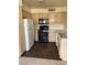 Kitchen with wood cabinets, black appliances, and laminate countertops at 5710 E Tropicana Ave # 2033, Las Vegas, NV 89122