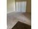 Spacious living room featuring neutral carpet, vertical blinds, and vinyl flooring at 5710 E Tropicana Ave # 2033, Las Vegas, NV 89122