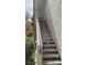 Exterior staircase leading up to a unit, featuring a green railing at 5710 E Tropicana Ave # 2033, Las Vegas, NV 89122