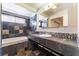 Bathroom featuring a bath tub, patterned stone tile and vanity with a sink at 6213 Burgundy Way, Las Vegas, NV 89107