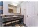 Bathroom featuring a stone tile vanity with a sink and a large mirror at 6213 Burgundy Way, Las Vegas, NV 89107