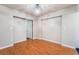 Bedroom featuring wood floors, neutral walls and a modern light fixture at 6213 Burgundy Way, Las Vegas, NV 89107