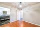 Bedroom with wood floors, neutral walls, modern light fixture and bathroom and closet access at 6213 Burgundy Way, Las Vegas, NV 89107