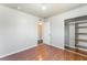 A bedroom with wood floors, a closet and doorway, and neutral paint scheme at 6213 Burgundy Way, Las Vegas, NV 89107