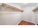 Walk in closet with wood floors and open white shelving at 6213 Burgundy Way, Las Vegas, NV 89107