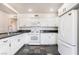 Well-lit kitchen featuring white cabinets, dark countertops and a stainless steel fridge at 6213 Burgundy Way, Las Vegas, NV 89107