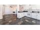 Bright kitchen featuring white cabinets, dark countertops and stainless sink overlooking living area at 6213 Burgundy Way, Las Vegas, NV 89107