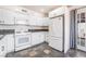 Kitchen featuring white cabinets, dark countertops, stainless steel appliances and a glass door to outside at 6213 Burgundy Way, Las Vegas, NV 89107
