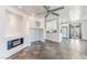Open living area with a view to a modern kitchen, fireplace, and slate flooring at 6213 Burgundy Way, Las Vegas, NV 89107