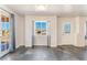 Bright living room with slate floors, a large window, and a decorative front door at 6213 Burgundy Way, Las Vegas, NV 89107