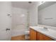 Clean bathroom featuring white tiles, a tub and shower combo, and a wooden vanity at 6234 Pangea Ave, Las Vegas, NV 89139