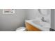 Compact half bathroom features white sink with wood vanity and window for natural light at 6234 Pangea Ave, Las Vegas, NV 89139