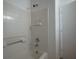 White tiled bathtub with brushed metal fixtures in a well-lit bathroom at 6234 Pangea Ave, Las Vegas, NV 89139