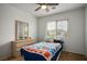 Cozy bedroom with ceiling fan, window, and a comfortable bed with blue bedding at 6234 Pangea Ave, Las Vegas, NV 89139