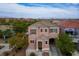 Two-story home with a cozy front porch, manicured landscaping, and a private driveway at 6234 Pangea Ave, Las Vegas, NV 89139