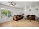 Bright living room featuring tile floors, comfortable seating, and a ceiling fan, perfect for relaxation and entertaining at 6234 Pangea Ave, Las Vegas, NV 89139