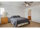 Comfortable main bedroom with a dark gray bed, wood dresser, and neutral carpet at 6234 Pangea Ave, Las Vegas, NV 89139