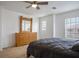 Spacious main bedroom with a light wood dresser, a ceiling fan, and neutral carpet at 6234 Pangea Ave, Las Vegas, NV 89139