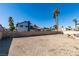 Large backyard with cinder block fence, palm trees and potential for landscaping and customization at 6357 Vicuna Dr, Las Vegas, NV 89146