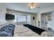 Comfortable bedroom featuring a ceiling fan, a mounted TV, and a sunlit window seat at 6357 Vicuna Dr, Las Vegas, NV 89146