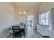 Inviting dining room with gray wood floors, modern chandelier, and a view into the updated kitchen at 6357 Vicuna Dr, Las Vegas, NV 89146