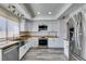 Modern kitchen featuring stainless steel appliances, white cabinets, butcher block countertops, and stylish lighting at 6357 Vicuna Dr, Las Vegas, NV 89146
