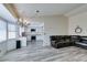 Bright, open-concept living space with modern flooring connecting the living room, kitchen, and breakfast nook at 6357 Vicuna Dr, Las Vegas, NV 89146
