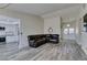 Open-concept living room, dining area and kitchen with updated wood-look flooring at 6357 Vicuna Dr, Las Vegas, NV 89146