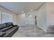 Living room with a view of dining area, featuring gray wood-look floors and natural light at 6357 Vicuna Dr, Las Vegas, NV 89146